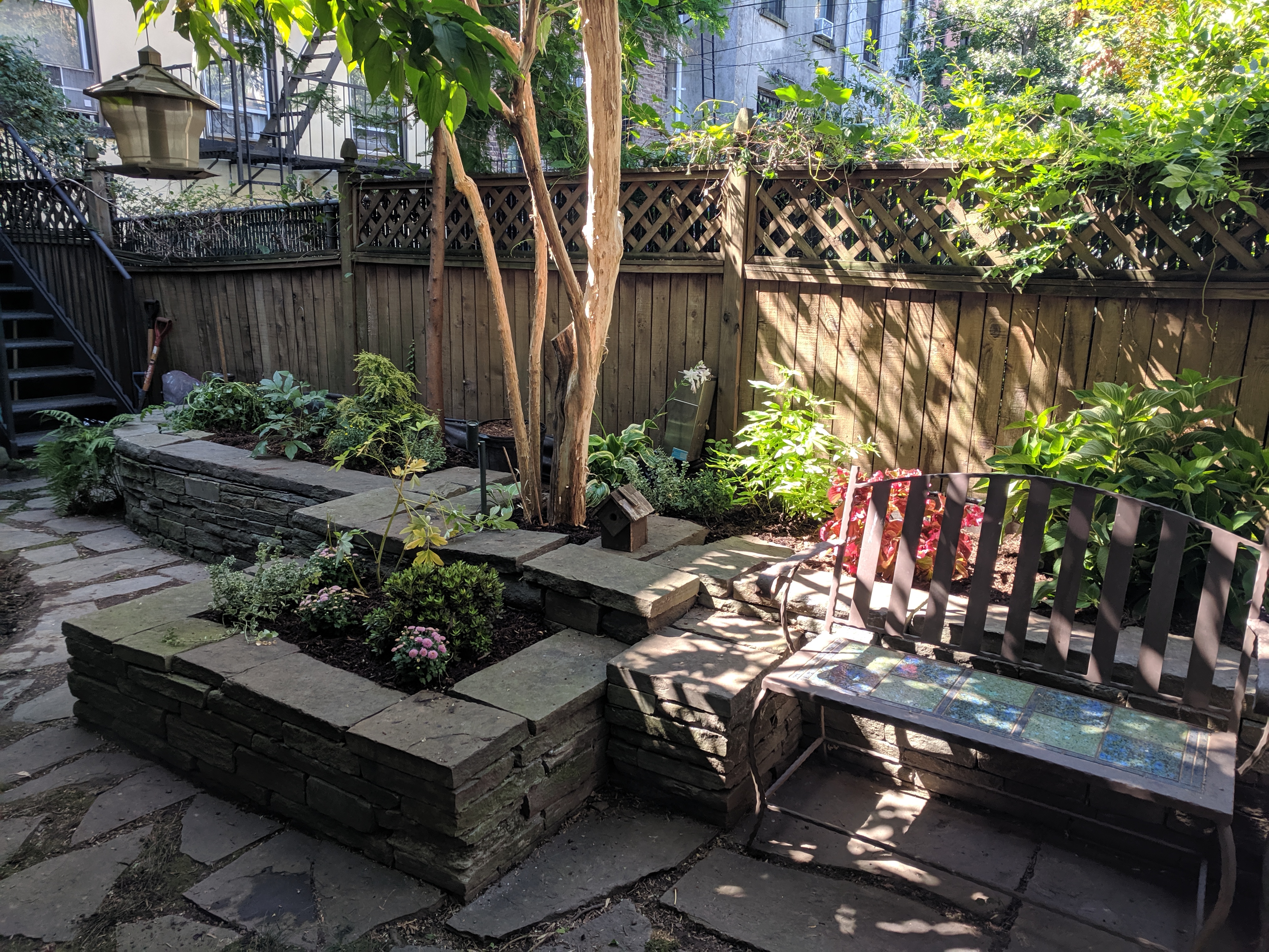 Stone-edge planter beds in Backyard Brookly Garden